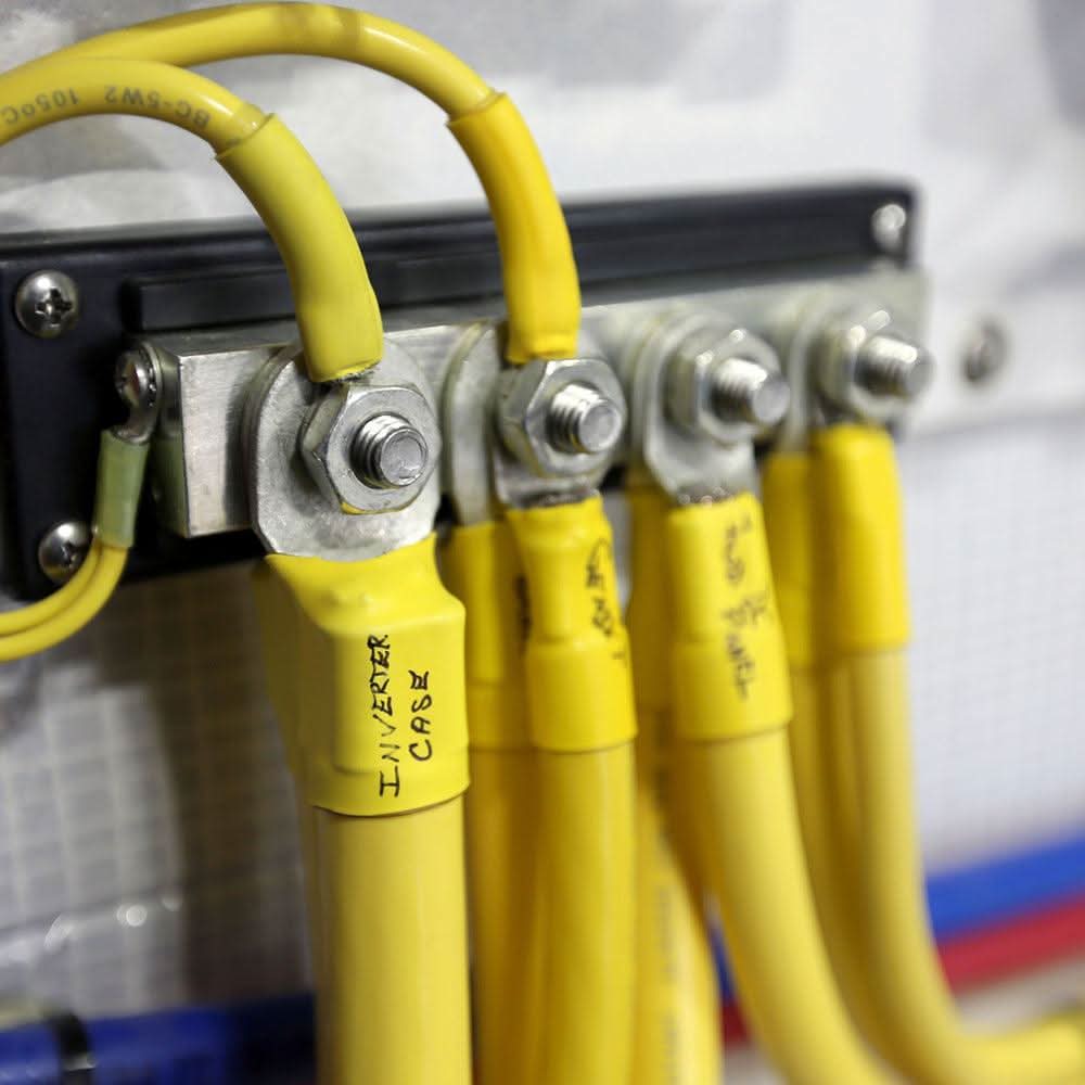 Blue Sea 2104 PowerBar 600AMP cable connector with 4 yellow 3/8-16 stud terminals attached to wires