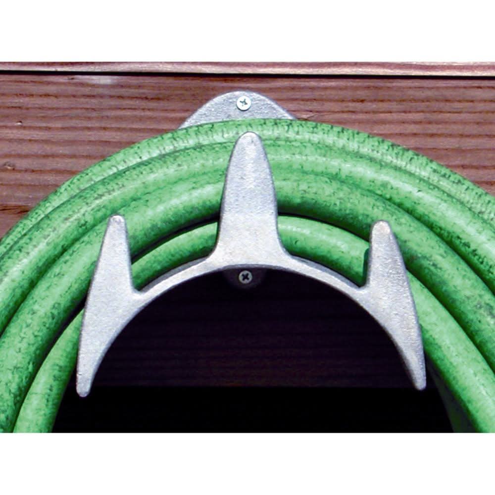 Schaefer Handi-Hanger mounted on wood holding coiled green hose in cockpit or stern pulpit.