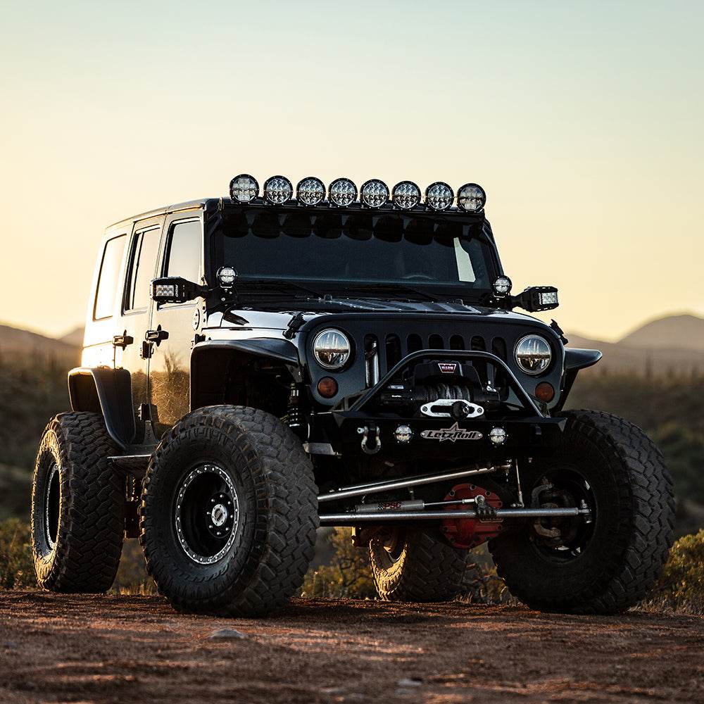 RIGID Industries 360-Series 6" LED off-road fog light with red backlight and black housing mounted on Jeep Wrangler