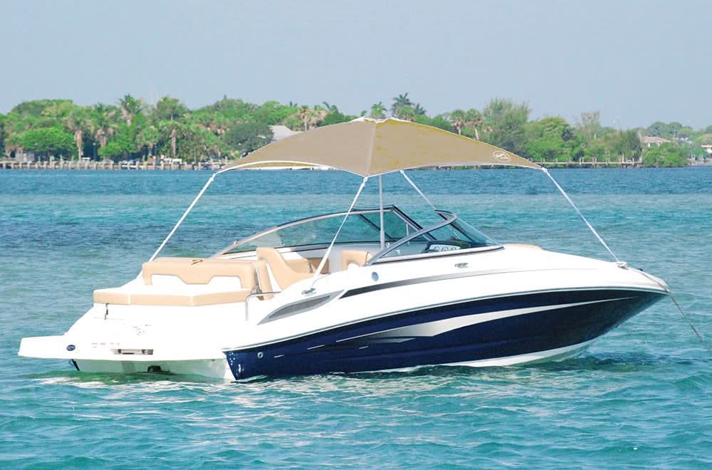 AnchorShade III sand-colored marine umbrella mounted on a white speedboat on water