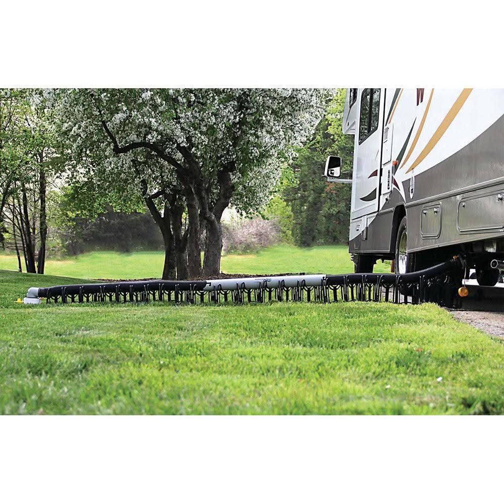 Camco Sidewinder plastic sewer hose support holding RV hose over lawn for stable drainage