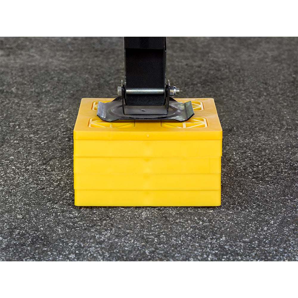 Camco FasTen yellow leveling blocks stacked under jack for RV support