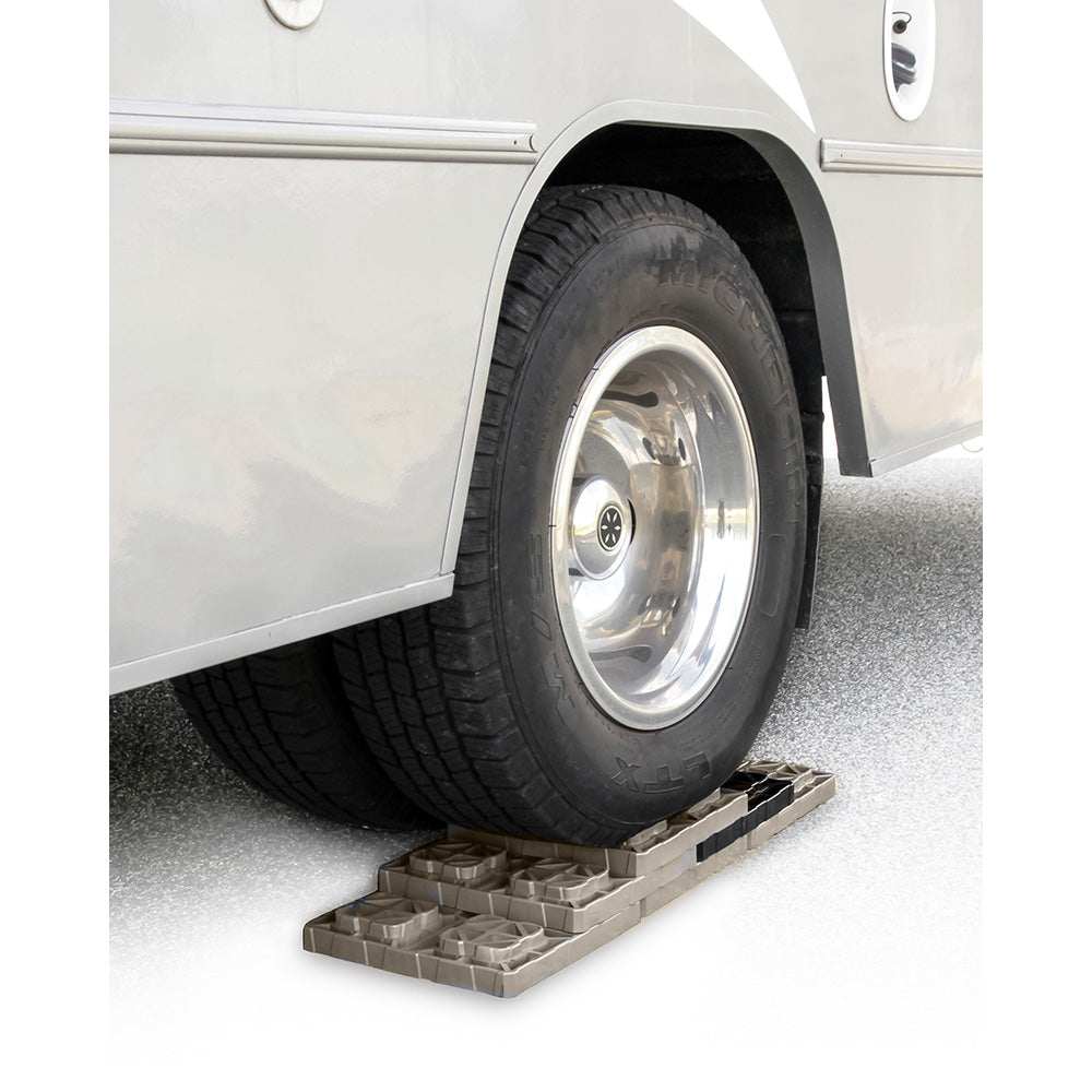 Camco FasTen Leveling Blocks with T-Handle supporting RV tire for stable leveling