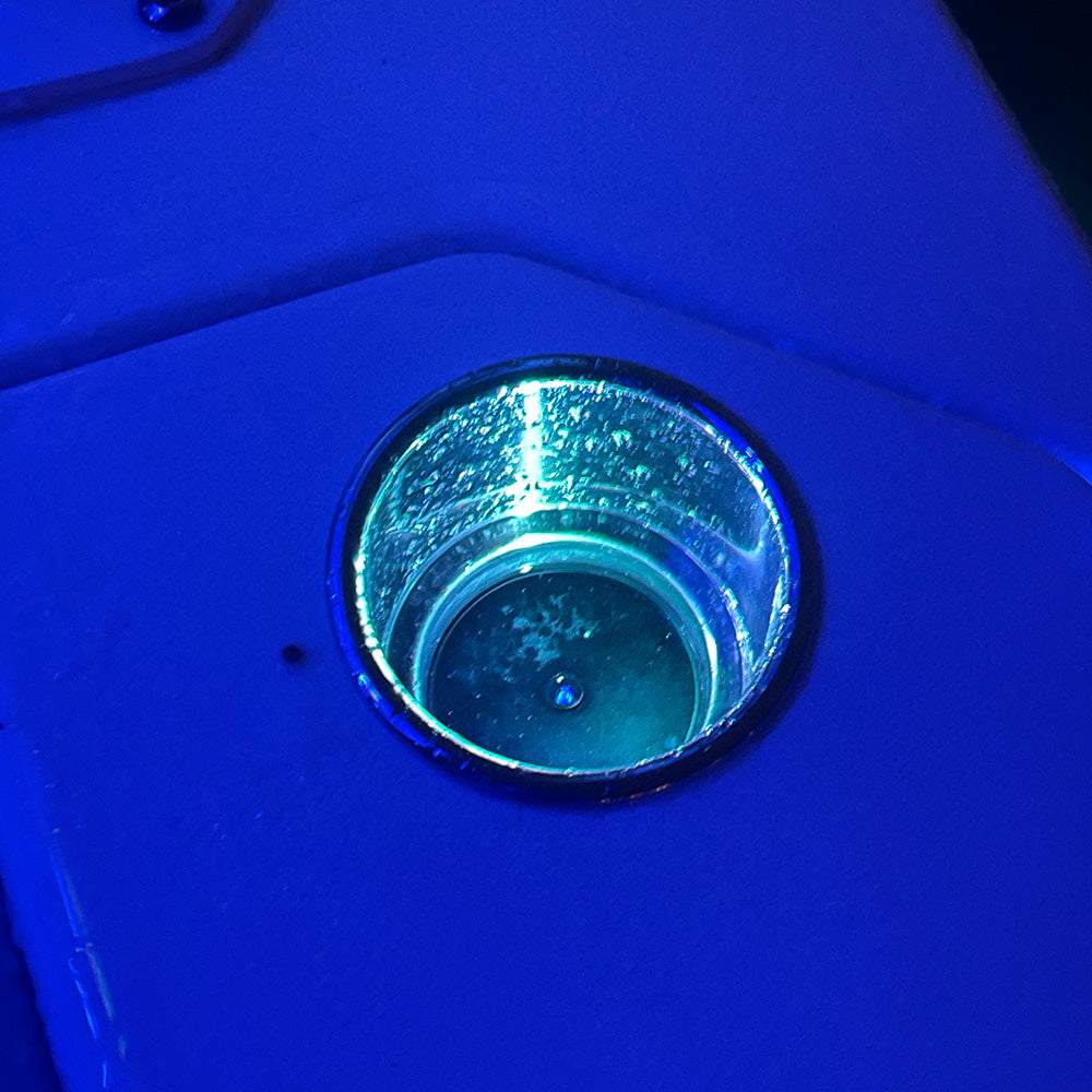 Shadow-Caster Round Accent Light RGB in black anodized aluminum housing installed in panel cup holder emitting blue light